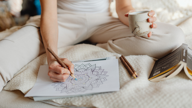 Designer analysing colour theory using colour wheels, swatches, and digital palettes, illustrating colour harmony and visual balance in graphic design.