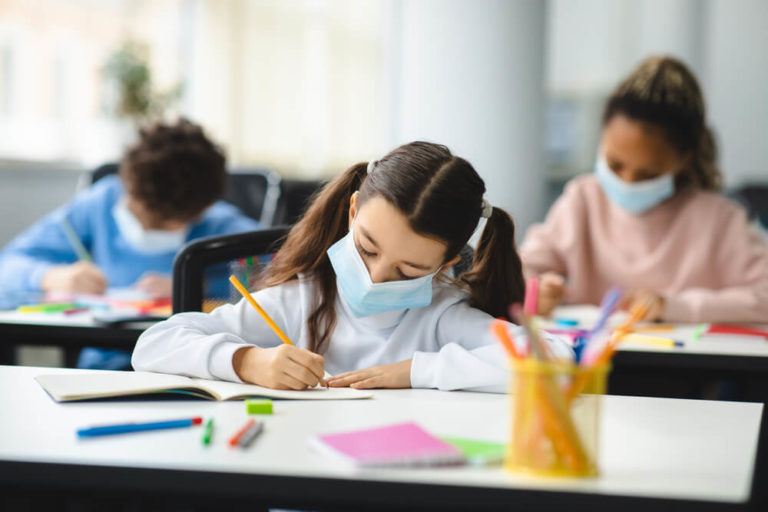 Students wearing protective masks in classroom