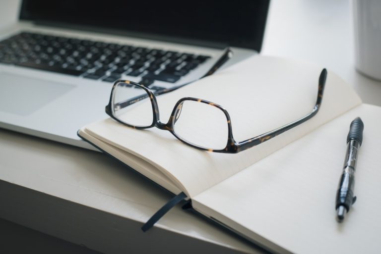A pair of spectacle on notebook