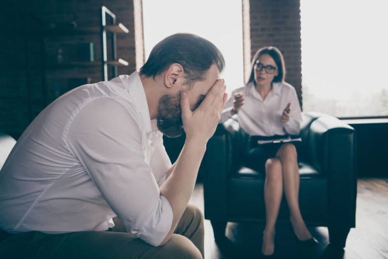 Stressed man with a female therapist