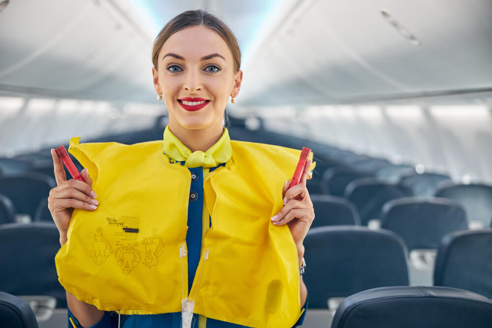 Air cabin crew demonstrating safety mannuals