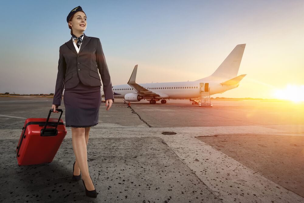 Cabin crew walking in front of an aeroplane