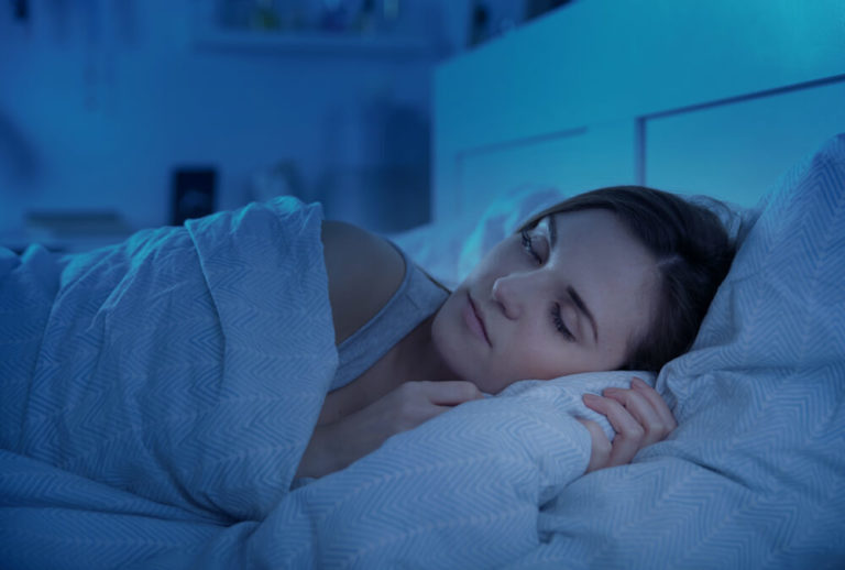 Woman calmly sleeping in bed