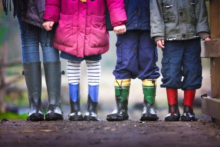 Students standing on mud