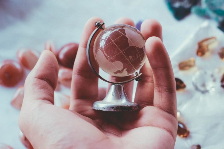 miniature globe on a palm