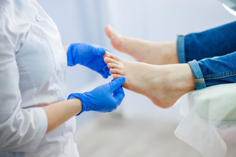 podiatrist doing treatment on a patient's feet