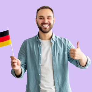 A cheerful man holding a German flag in one hand and making an "OK" sign with the other hand.