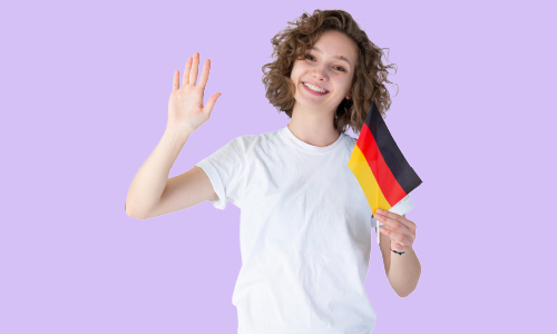 A cheerful girl with curly hair, wearing a white top, proudly holding a German flag.