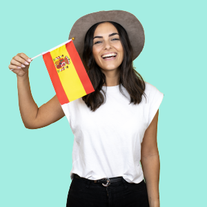 A beautiful girl in a white top and gray hat, holding a Spanish flag.