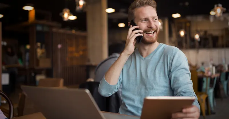 Online phone calls in a remote work setting showing a tech-savvy professional handling calls and digital tasks simultaneously