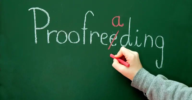 Proofreading correction on a chalkboard with the word 'Proofreeding' being edited to the correct spelling 'Proofreading' using a red marker