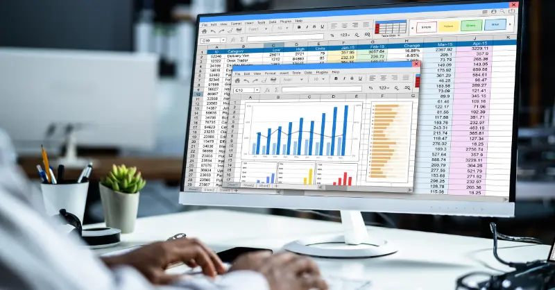 nalyzing data using formulas and functions in Microsoft Excel with charts and spreadsheets displayed on a computer screen