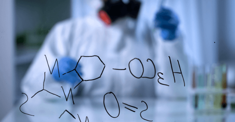 Toxicologist (Pharmaceutical) in full protective gear analyzing hazardous compounds in high-security lab, with chemical structure H₃CO–S=O on glass surface.